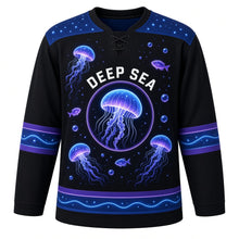 Load image into Gallery viewer, Bioluminescent Deep Sea Original Hockey Jersey in Trench Black, front view – glowing jellyfish and deep-sea light specks with jellyfish bubble-ring crest, custom name and number