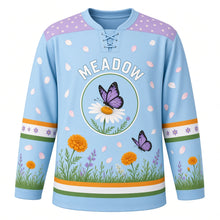 Load image into Gallery viewer, Butterfly Meadow Original Hockey Jersey in Sky Meadow, front view – three butterflies over a wildflower meadow and butterfly-on-daisy crest, custom name and number