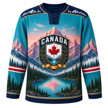 Load image into Gallery viewer, Canada Rocky Mountain Majesty Original Hockey Jersey in Glacier Teal, front view – layered Rocky Mountain peaks, glacier lake, pines and maple-leaf shield crest, custom name and number