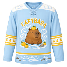Load image into Gallery viewer, Capybara Hot Spring Original Hockey Jersey in Spring Water Blue, front view – relaxed capybara soaking in a steaming hot spring with yuzu fruits and capybara crest, custom name and number