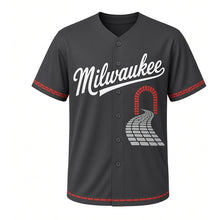 Load image into Gallery viewer, Cobblestone Alley Milwaukee Baseball Jersey in Cobble Charcoal, front view – cobblestone lane and arched brick doorway graphic with keystone crest, custom name and number