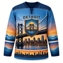 Load image into Gallery viewer, Detroit Bridge Twilight Original Hockey Jersey in Bridge Steel Blue, front view – sunset-to-starlight sky over a suspension bridge and river skyline, custom name and number