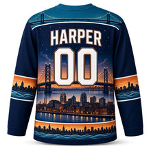 Load image into Gallery viewer, Detroit Bridge Twilight Original Hockey Jersey in River Navy, back view with your name and number under a starry suspension bridge skyline