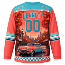 Load image into Gallery viewer, Detroit Tailfin Cruiser Boulevard Original Hockey Jersey in Sunset Coral, back view with your name and number above a retro cruiser and autumn storefronts