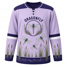 Load image into Gallery viewer, Dragonfly Marsh Original Hockey Jersey in Iris Lilac, front view – dragonflies over marsh reeds and cattails with dragonfly crest, custom name and number