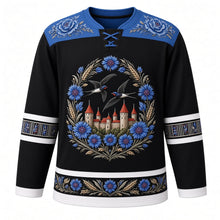 Load image into Gallery viewer, Estonia Original Hockey Jersey in Baltic Night Black, front view – ornate Muhu-embroidered cornflower wreath crest with barn swallows over Tallinn's limestone towers, floral embroidery yoke, detailed artwork, custom name and number