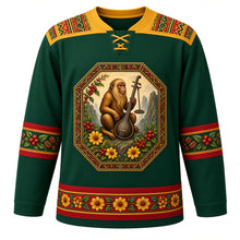 Load image into Gallery viewer, Ethiopia Original Hockey Jersey in Simien Green, front view – ornate tibeb-framed crest with a Simien gelada, jebena coffee pot, coffee cherries and adey abeba daisies, tibeb-weave yoke, detailed artwork, custom name and number