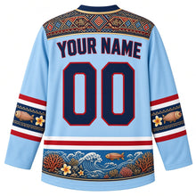 Load image into Gallery viewer, Fiji Original Hockey Jersey in Pacific Sky Blue, back view with your name and number – masi-pattern yoke and coral reef hem band, detailed artwork