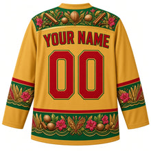 Load image into Gallery viewer, Grenada Original Hockey Jersey in Nutmeg Gold, back view with your name and number – ornate nutmeg and bougainvillea spice-garden yoke with carnival-feather sleeve bands, finely detailed artwork