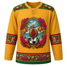 Load image into Gallery viewer, Grenada Original Hockey Jersey in Nutmeg Gold, front view – ornate nutmeg-and-mace crest with Grenada Dove, cocoa pods, bougainvillea and steelpan, spice-garden yoke, detailed illustrated artwork, custom name and number