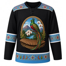 Load image into Gallery viewer, Guatemala Original Hockey Jersey in Obsidian Black, front view – ornate quetzal, Monja Blanca orchid, Lake Atitlán volcanoes and marimba crest, huipil-brocade yoke, detailed illustrated artwork, custom name and number