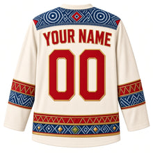 Load image into Gallery viewer, Guinea Original Hockey Jersey in Cotton Ivory, back view with your name and number – ornate indigo léppi resist-dye yoke with rope-lacing chevron and indigo-circle bands, finely detailed artwork