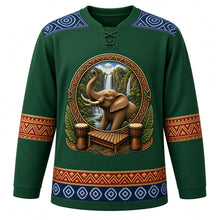 Load image into Gallery viewer, Guinea Original Hockey Jersey in Fouta Djallon Green, front view – ornate elephant before Fouta Djallon waterfalls with djembes and balafon, indigo léppi yoke, detailed illustrated artwork, custom name and number