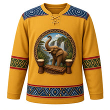Load image into Gallery viewer, Guinea Original Hockey Jersey in Savanna Gold, front view – ornate elephant before Fouta Djallon waterfalls with djembes and balafon, indigo léppi yoke, detailed illustrated artwork, custom name and number