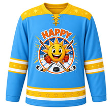 Load image into Gallery viewer, Happy Vibes Emotion Hockey Jersey in Sunny Sky Blue, front view – grinning sun mascot with starbursts and crossed hockey sticks, custom name and number