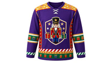 Load image into Gallery viewer, Ugly Christmas Nutcracker Hockey Jersey in Royal Purple, front view of a hockey jersey with royal purple body, gold shoulder yoke printed with stars and candy stripes, red side panels with drums and blocks, emerald present-print elbow bands, candy stripe cuffs and a star and present hem stripe band, and a shield crest with a toy-soldier nutcracker, stars and wrapped presents on the chest, custom name and number