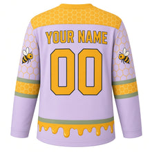 Load image into Gallery viewer, Honeycomb Bees Original Hockey Jersey in Lavender Meadow, back view with your name and number – hexagon yoke and honey-drip hem stripes