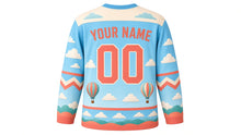 Load image into Gallery viewer, Hot Air Balloon Skies Original Hockey Jersey in Sky Blue, back view with your name and number – cloud-pattern yoke and balloon-stripe chevron sleeve bands