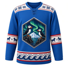 Load image into Gallery viewer, Iceland Original Hockey Jersey in Fjord Blue, front view – basalt-column crest of puffins under the aurora, ornate lopapeysa knit-pattern yoke, detailed artwork, custom name and number