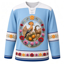 Load image into Gallery viewer, Israel Original Hockey Jersey in Galilee Sky Blue, front view – ornate hoopoe, Jaffa orange and Nubian ibex crest, anemone wreath and Bauhaus White City geometric yoke, detailed illustrated artwork, custom name and number