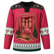 Load image into Gallery viewer, Jordan Original Hockey Jersey in Petra Rose Red, front view – ornate Petra Treasury crest with Sinai rosefinch, black iris and Wadi Rum dunes, tatreez cross-stitch yoke, detailed illustrated artwork, custom name and number