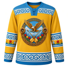 Load image into Gallery viewer, Kazakhstan Original Hockey Jersey in Golden Eagle Gold, front view – ornate golden eagle over Tian Shan peaks crest with dombra and wild tulips, qoshqar muiiz ram's-horn felt yoke, detailed illustrated artwork, custom name and number