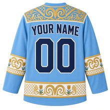 Load image into Gallery viewer, Kazakhstan Original Hockey Jersey in Steppe Sky Blue, back view – ornate ram's-horn felt-mosaic yoke with tulip and horn-scroll sleeve bands, with your name and number