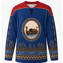 Load image into Gallery viewer, Kuomboka Ceremony Original Hockey Jersey in Zambezi Blue, front view with themed artwork and clean crest