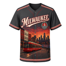 Load image into Gallery viewer, Lakefront Streetcar Milwaukee Baseball Jersey in Rail Charcoal, front view – modern streetcar passing brick buildings and the lakefront, custom name and number