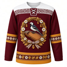 Load image into Gallery viewer, Latvia Original Hockey Jersey in Riga Maroon, front view – ornate daisy, oak-leaf and white wagtail wreath crest and Lielvārde belt weave yoke with finely detailed artwork, custom name and number