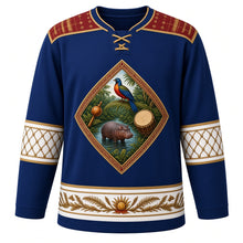 Load image into Gallery viewer, Liberia Original Hockey Jersey in Indigo Cloth Blue, front view – pepper bird, oil palm and pygmy hippo crest with saasaa rattle and drum, country-cloth strip-weave yoke and gourd bead-net sleeve bands, ornate detailed artwork, custom name and number