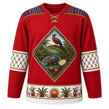 Load image into Gallery viewer, Liberia Original Hockey Jersey in Pepper Bird Red, front view – pepper bird, oil palm and pygmy hippo crest with saasaa rattle and drum, country-cloth strip-weave yoke and gourd bead-net sleeve bands, ornate detailed artwork, custom name and number