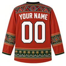 Load image into Gallery viewer, Libya Original Hockey Jersey in Leptis Red, back view with your name and number – Ghadames painted-geometry yoke, Amazigh kilim sleeve bands and date-palm hem band, ornate detailed artwork