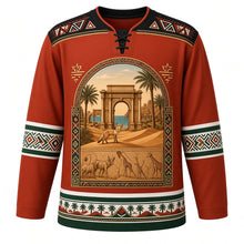 Load image into Gallery viewer, Libya Original Hockey Jersey in Leptis Red, front view – Leptis Magna arch and date palm crest with fennec fox and Acacus rock art, Ghadames painted-geometry yoke and Amazigh kilim sleeve bands, ornate detailed artwork, custom name and number
