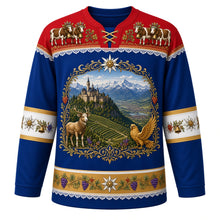 Load image into Gallery viewer, Liechtenstein Original Hockey Jersey in Rhine Valley Blue, front view – Vaduz Castle, vineyard and chamois crest in an edelweiss wreath, Alpabfahrt cow-procession yoke and edelweiss sleeve bands, ornate detailed artwork, custom name and number