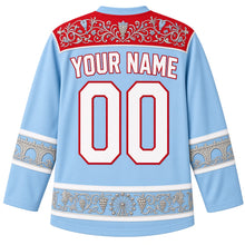 Load image into Gallery viewer, Luxembourg Original Hockey Jersey in Moselle Sky Blue, back view with your name and number – ornate vine-filigree yoke and matching detailed sleeve and hem bands