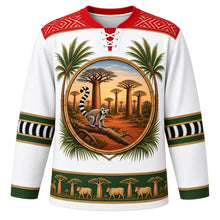 Load image into Gallery viewer, Madagascar Original Hockey Jersey in Lamba White, front view – ornate lamba-weave yoke and baobab-and-lemur crest, detailed illustrated artwork, custom name and number