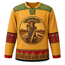 Load image into Gallery viewer, Mali Original Hockey Jersey in Sahel Gold, front view – bogolan mud-cloth yoke and kora-and-baobab crest with ornate detailed artwork, custom name and number