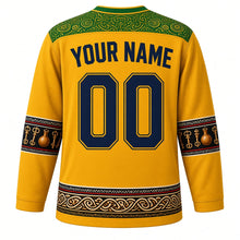 Load image into Gallery viewer, Mozambique Original Hockey Jersey in Cashew Gold, back view with your name and number – capulana wax-print yoke and timbila keyboard sleeve bands