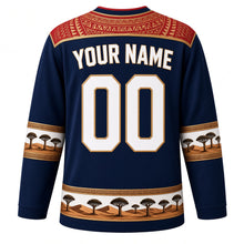 Load image into Gallery viewer, Namibia Original Hockey Jersey in Skeleton Coast Blue, back view with your name and number – Makalani basketry yoke and gold-braid sleeve bands