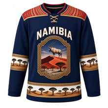 Load image into Gallery viewer, Namibia Original Hockey Jersey in Skeleton Coast Blue, front view – Makalani basketry yoke and gemsbok Namib dune crest with ornate detailed artwork, custom name and number