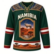 Load image into Gallery viewer, Namibia Original Hockey Jersey in Etosha Green, front view – Makalani basketry yoke and gemsbok Namib dune crest with ornate detailed artwork, custom name and number