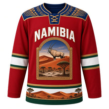 Load image into Gallery viewer, Namibia Original Hockey Jersey in Sossus Dune Red, front view – Makalani basketry yoke and gemsbok Namib dune crest with ornate detailed artwork, custom name and number
