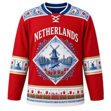 Load image into Gallery viewer, Netherlands Original Hockey Jersey in Tulip Red, front view – NETHERLANDS chest lettering, Hindeloopen-painted yoke and Delft-tile windmill crest in ornate detailed artwork, custom name and number