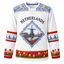 Load image into Gallery viewer, Netherlands Original Hockey Jersey in Porcelain White, front view – NETHERLANDS chest lettering, Hindeloopen-painted yoke and Delft-tile windmill crest in ornate detailed artwork, custom name and number