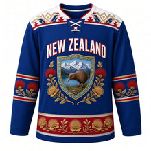 Load image into Gallery viewer, New Zealand Original Hockey Jersey in Tasman Blue, front view – NEW ZEALAND chest lettering, taniko-style yoke and kiwi-and-pohutukawa shield crest in ornate detailed artwork, custom name and number