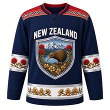 Load image into Gallery viewer, New Zealand Original Hockey Jersey in Southern Sky Navy, front view – NEW ZEALAND chest lettering, taniko-style yoke and kiwi-and-pohutukawa shield crest in ornate detailed artwork, custom name and number