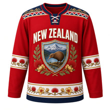Load image into Gallery viewer, New Zealand Original Hockey Jersey in Pohutukawa Red, front view – NEW ZEALAND chest lettering, taniko-style yoke and kiwi-and-pohutukawa shield crest in ornate detailed artwork, custom name and number