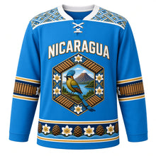 Load image into Gallery viewer, Nicaragua Original Hockey Jersey in Cocibolca Blue, front view – NICARAGUA chest lettering, Masaya hammock-weave yoke and guardabarranco volcano medallion crest in ornate detailed artwork, custom name and number