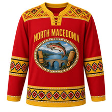 Load image into Gallery viewer, North Macedonia Original Hockey Jersey in Vardar Red, front view – folk cross-stitch embroidery yoke and pearl-ringed Lake Ohrid trout crest in ornate detailed artwork, custom name and number